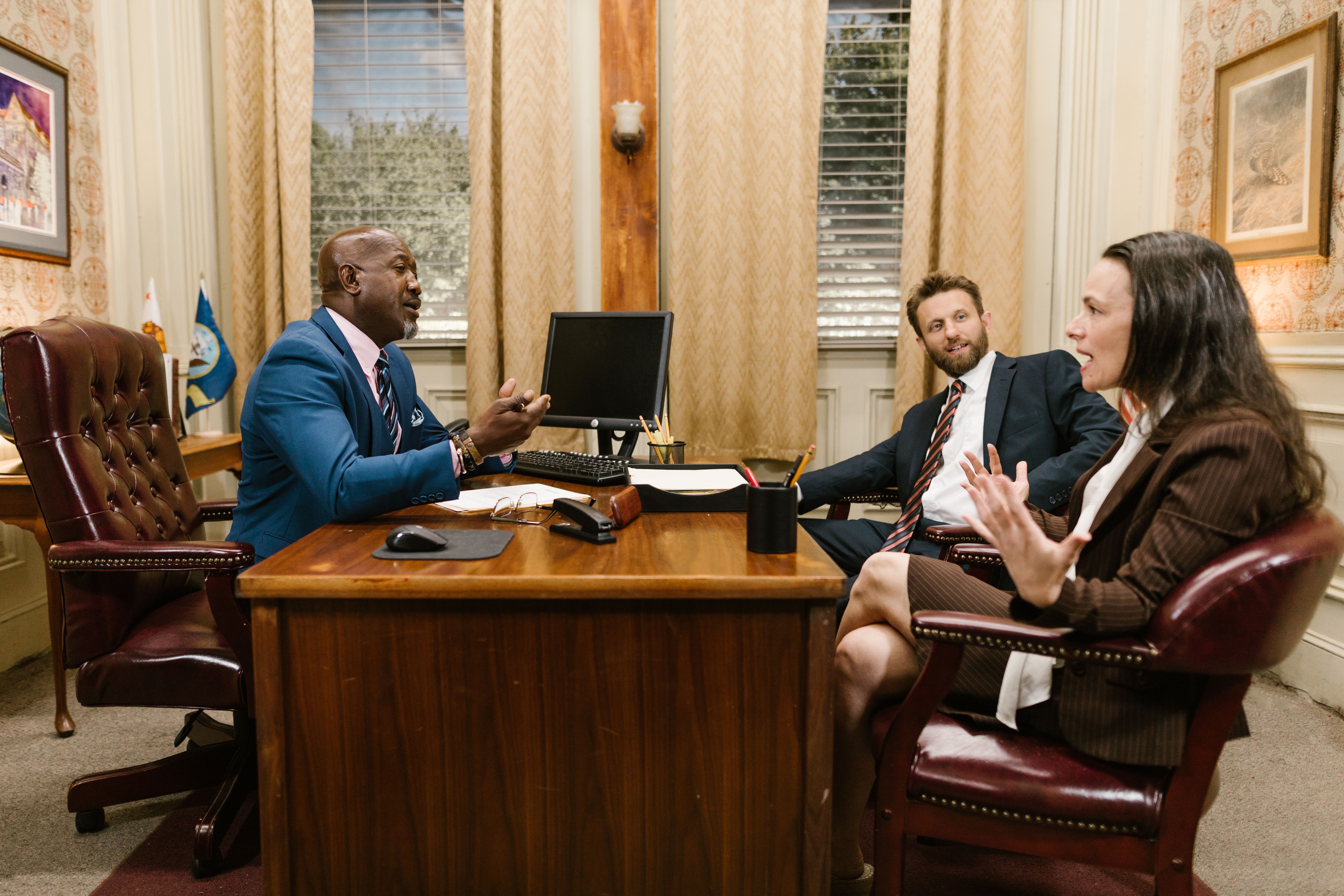 Three attorneys in a legal discussion at a law office