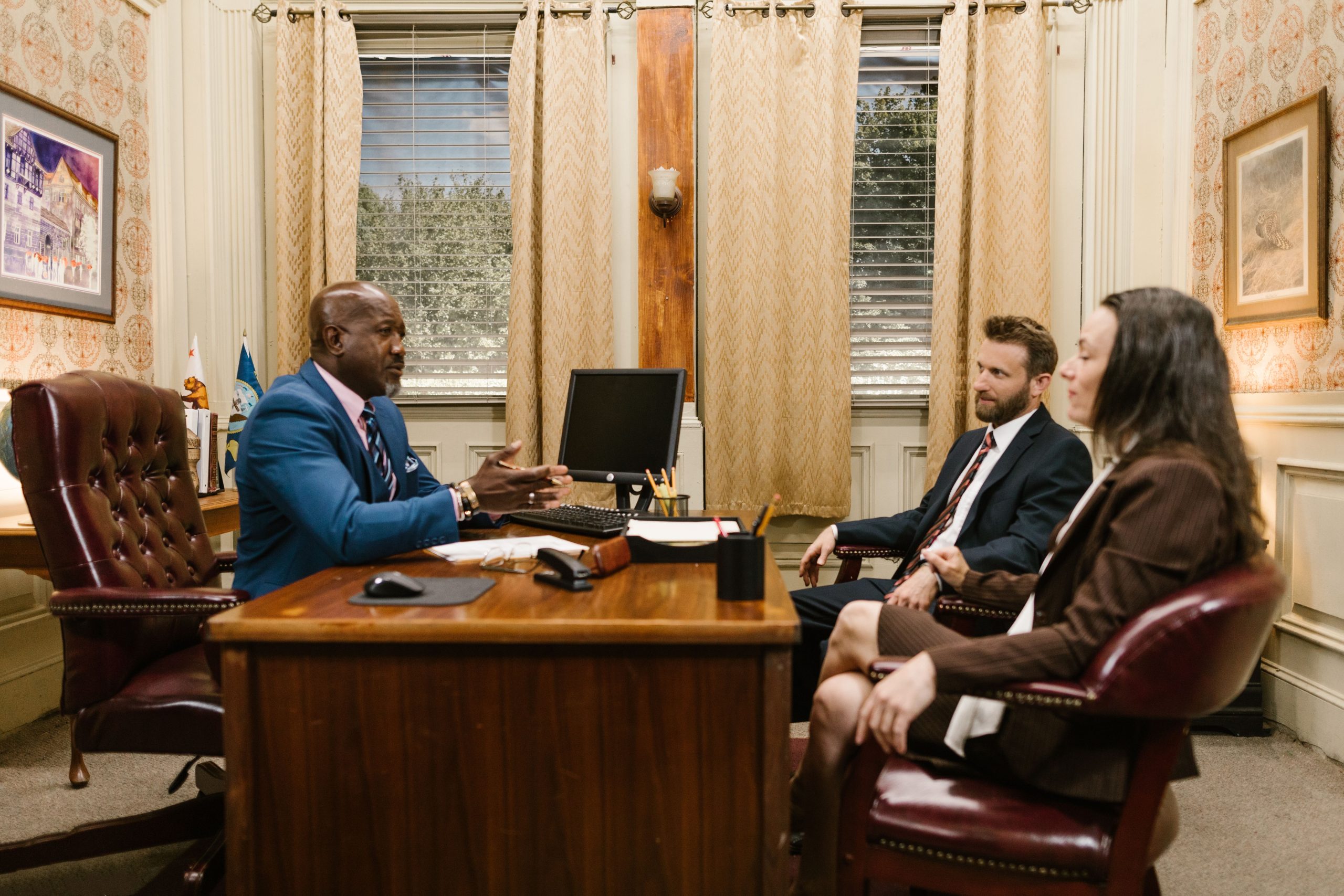 Lawyers discussing with a client in a professional office