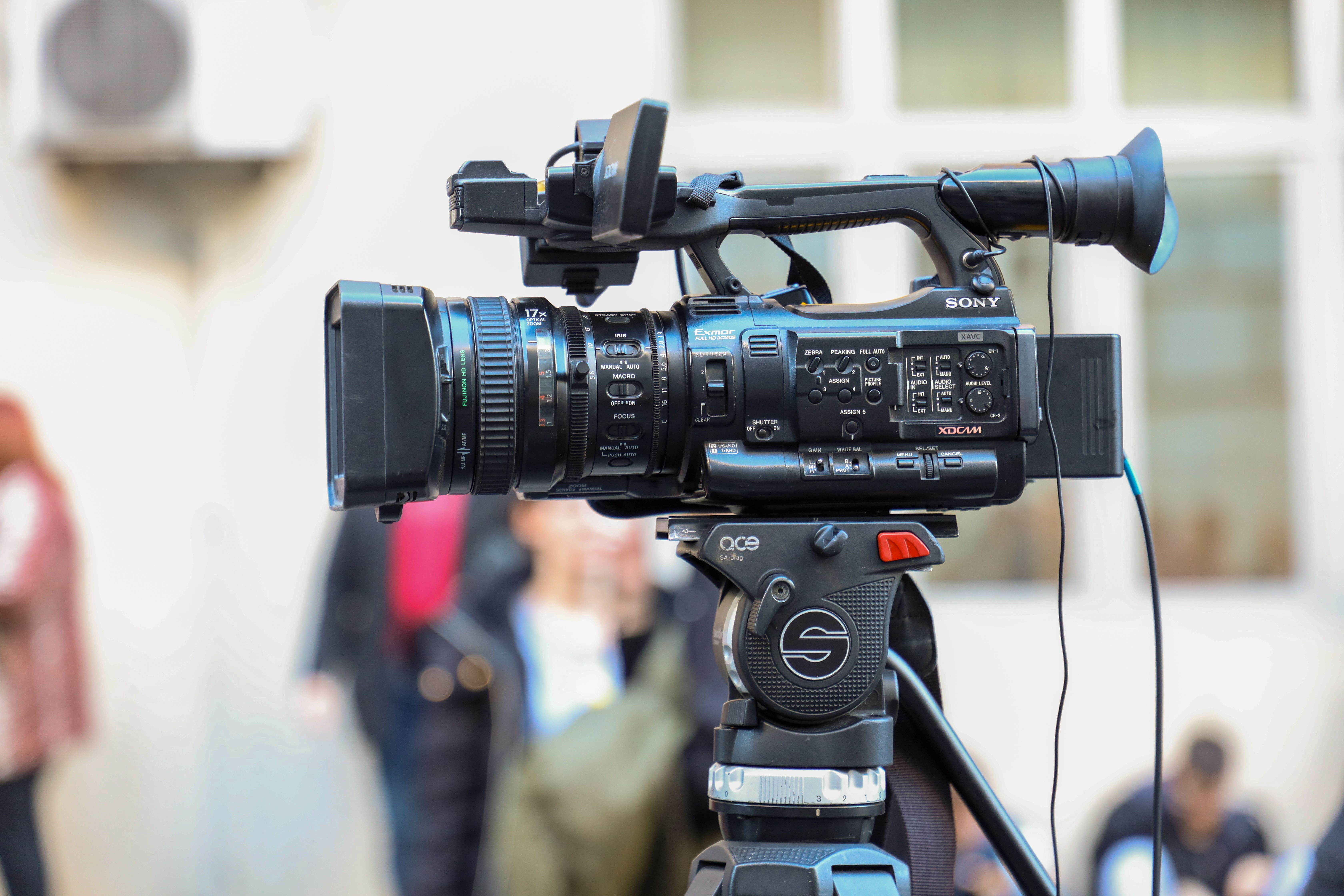 Professional video camera mounted on a tripod for an outdoor production.