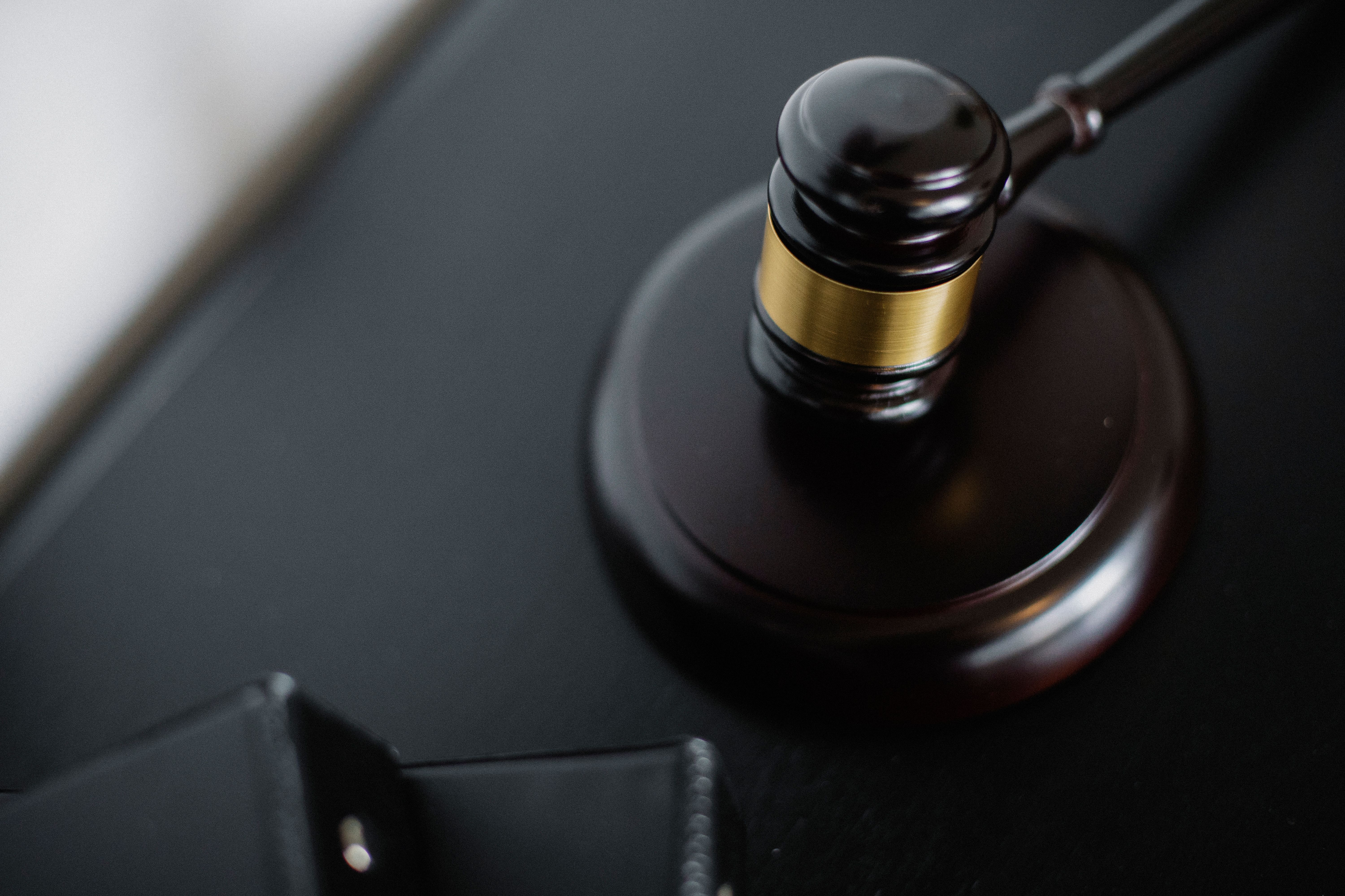 Wooden gavel on a table in a courtroom, seen from above