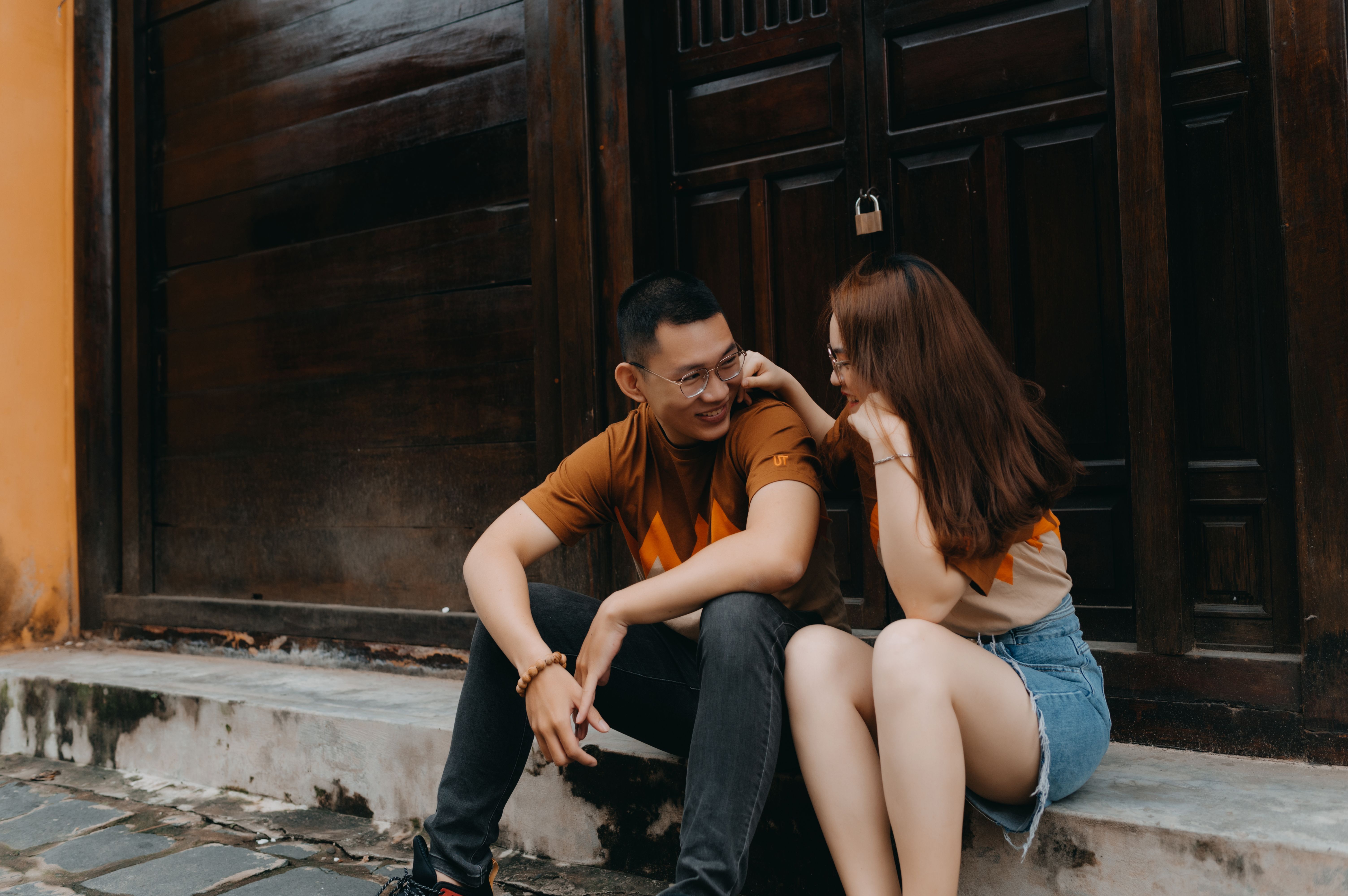 Young couple smiling and talking together on an urban street